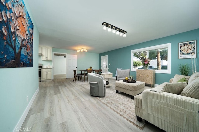 1405 W Saint Gertrude Pl, Santa Ana, CA 92704 - living room with light wood-style floors and baseboards