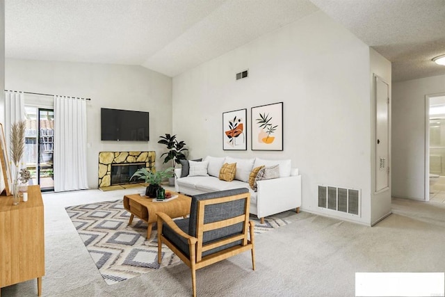 241 Saguaro Pl, Oceanside, CA 92057 - carpeted living area featuring a textured ceiling, vaulted ceiling, and a stone fireplace