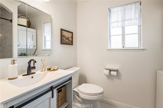 1125 Sheridan Ave Unit 68, Chico, CA 95926 - full bathroom featuring toilet, stacked washing machine and dryer, vanity, healthy amount of natural light, and ornamental molding