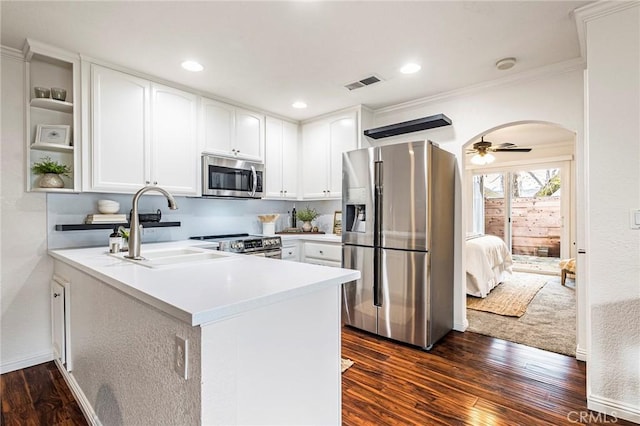 1125 Sheridan Ave Unit 68, Chico, CA 95926 - kitchen with appliances with stainless steel finishes, a peninsula, dark wood-style flooring, light countertops, and crown molding