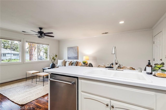 1125 Sheridan Ave Unit 68, Chico, CA 95926 - kitchen with ornamental molding, stainless steel dishwasher, a sink, dark wood-style flooring, and white cabinets