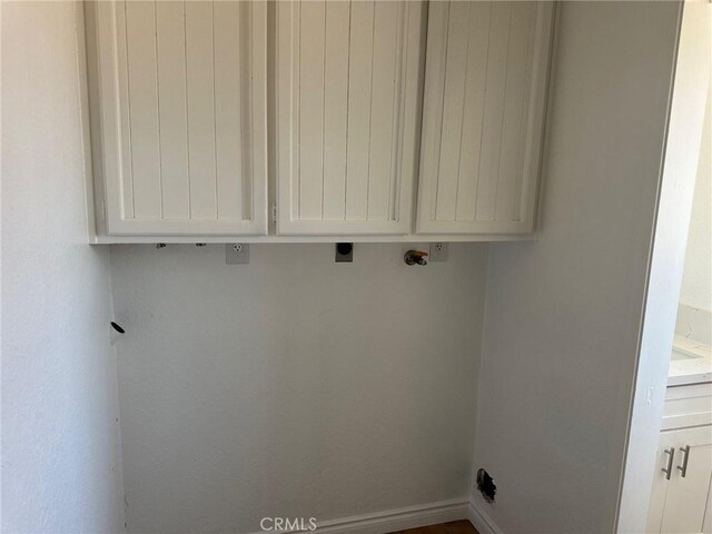16485 Wintun Rd, Apple Valley, CA 92307 - laundry room featuring electric dryer hookup, cabinet space, and baseboards