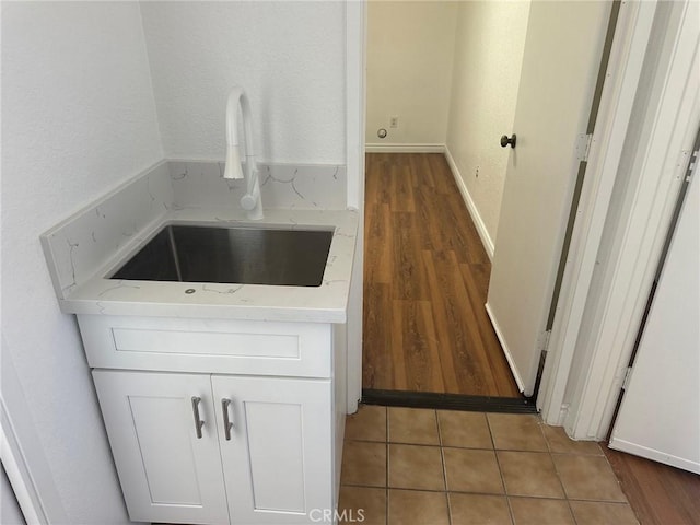 16485 Wintun Rd, Apple Valley, CA 92307 - kitchen featuring a sink, white cabinets, light countertops, and wood finished floors