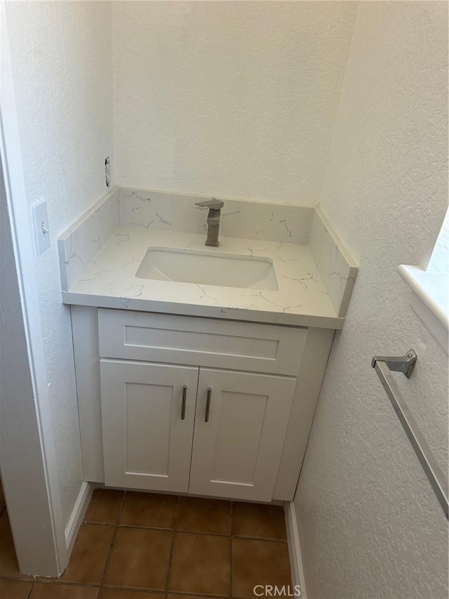 16485 Wintun Rd, Apple Valley, CA 92307 - bathroom featuring a textured wall, vanity, tile patterned floors, and baseboards