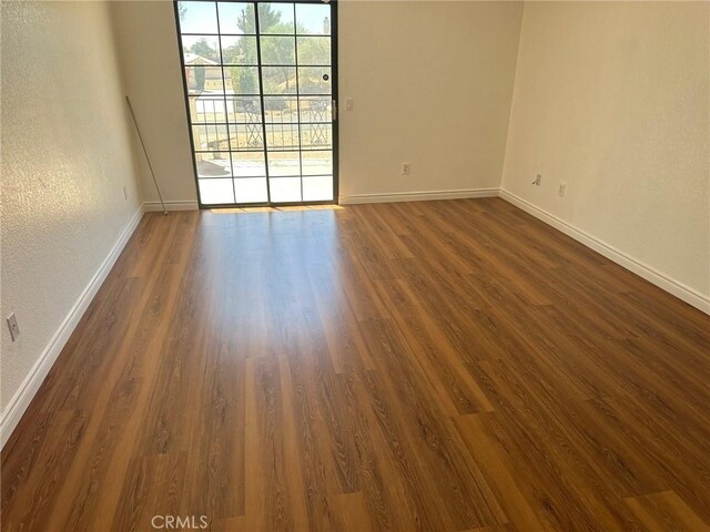 16485 Wintun Rd, Apple Valley, CA 92307 - spare room featuring baseboards, dark wood-type flooring, and a textured wall