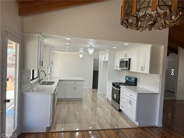 16485 Wintun Rd, Apple Valley, CA 92307 - kitchen with appliances with stainless steel finishes, a sink, a chandelier, light countertops, and recessed lighting