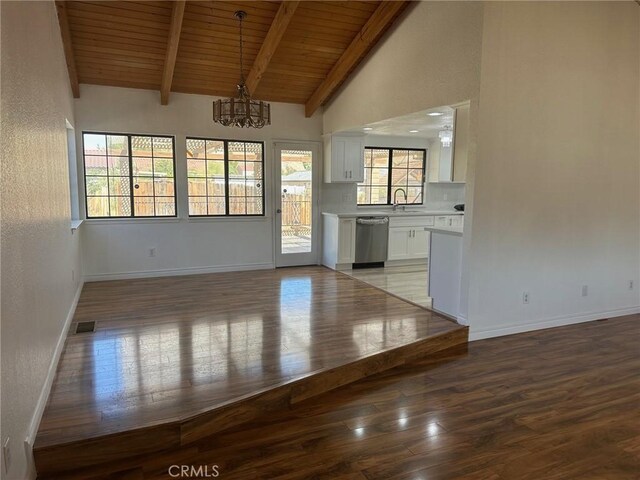 16485 Wintun Rd, Apple Valley, CA 92307 - unfurnished living room featuring wood ceiling with exposed beams, a chandelier, wood finished floors, baseboards, and high vaulted ceiling