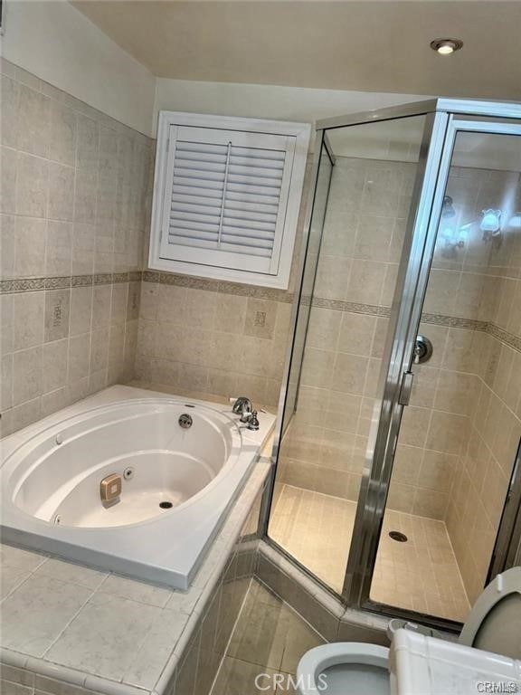 19023 Cantlay St, Reseda, CA 91335 - bathroom with a whirlpool tub, a shower stall, and tile walls