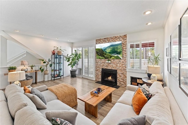 19431 Ranch Ln Unit 101, Huntington Beach, CA 92648 - living area with plenty of natural light, a fireplace, recessed lighting, wood finished floors, and baseboards