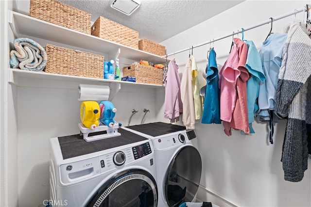 19431 Ranch Ln Unit 101, Huntington Beach, CA 92648 - laundry area featuring washer and dryer and a textured ceiling