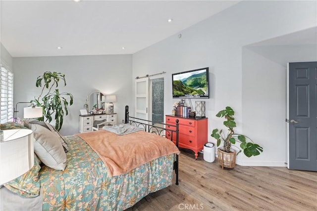 19431 Ranch Ln Unit 101, Huntington Beach, CA 92648 - bedroom featuring wood finished floors, a barn door, baseboards, and recessed lighting