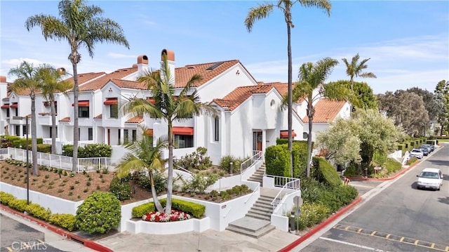 19431 Ranch Ln Unit 101, Huntington Beach, CA 92648 - view of building exterior featuring a residential view, uncovered parking, and stairway