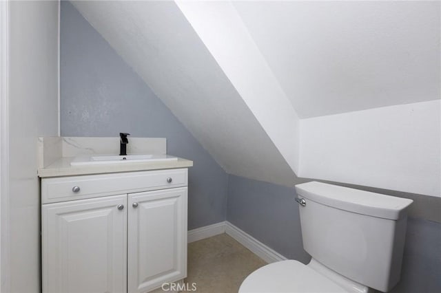 799 Fern Dr, Crestline, CA 92325 - half bath featuring toilet, vanity, lofted ceiling, and baseboards