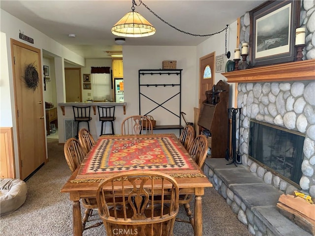 762 Esquimoux Dr, Green Valley Lake, CA 92341 - dining area featuring carpet floors and a stone fireplace