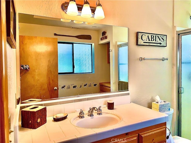 762 Esquimoux Dr, Green Valley Lake, CA 92341 - full bath with vanity, a shower with shower door, and a chandelier
