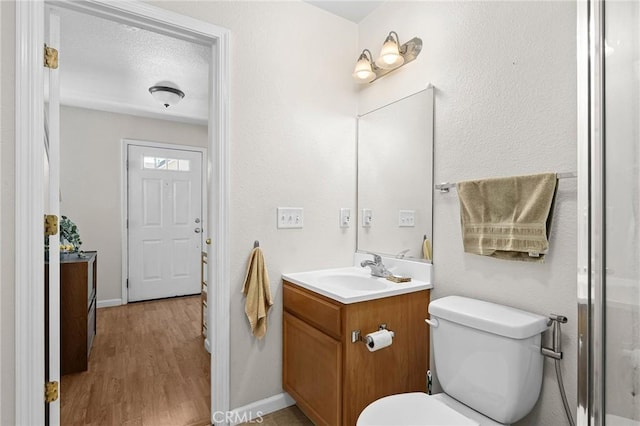 2099 Hartford Dr Unit 7, Chico, CA 95928 - full bath featuring vanity, toilet, wood finished floors, and baseboards