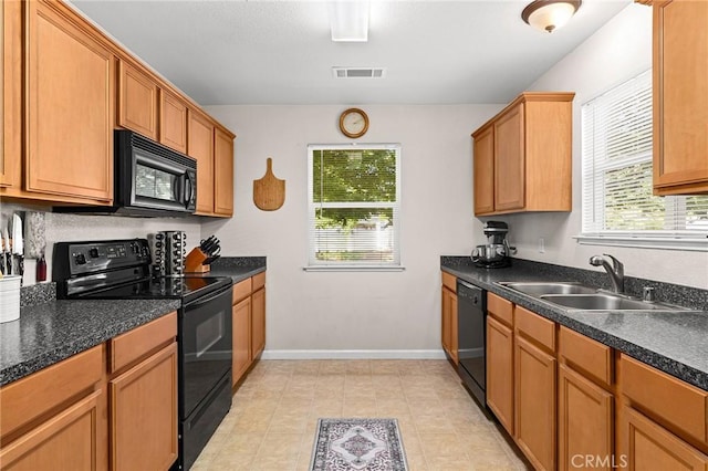 2099 Hartford Dr Unit 7, Chico, CA 95928 - kitchen with black appliances, a sink, dark countertops, brown cabinetry, and baseboards