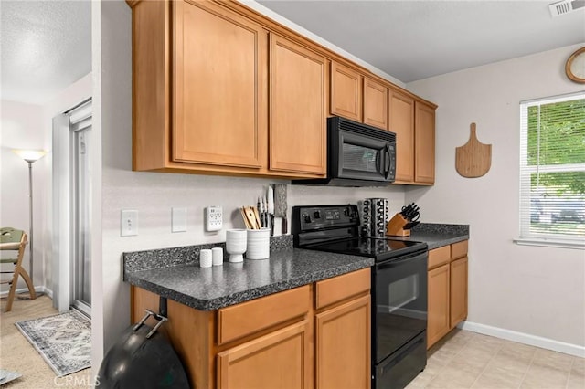 2099 Hartford Dr Unit 7, Chico, CA 95928 - kitchen featuring black appliances, dark countertops, baseboards, and brown cabinets