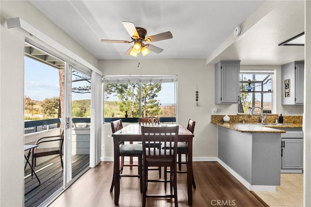 26762 Claudette St Unit 417, Canyon Country, CA 91351 - dining space featuring healthy amount of natural light, ceiling fan, baseboards, and wood finished floors