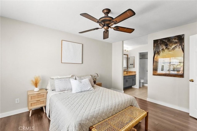 26762 Claudette St Unit 417, Canyon Country, CA 91351 - bedroom featuring baseboards, wood finished floors, connected bathroom, and ceiling fan