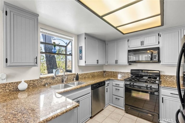 26762 Claudette St Unit 417, Canyon Country, CA 91351 - kitchen with black appliances, a sink, stone counters, light tile patterned floors, and gray cabinets