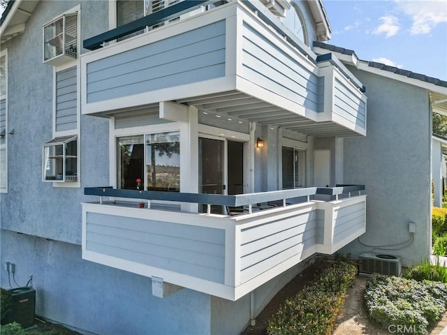 26762 Claudette St Unit 417, Canyon Country, CA 91351 - doorway to property featuring a balcony, stucco siding, and central AC