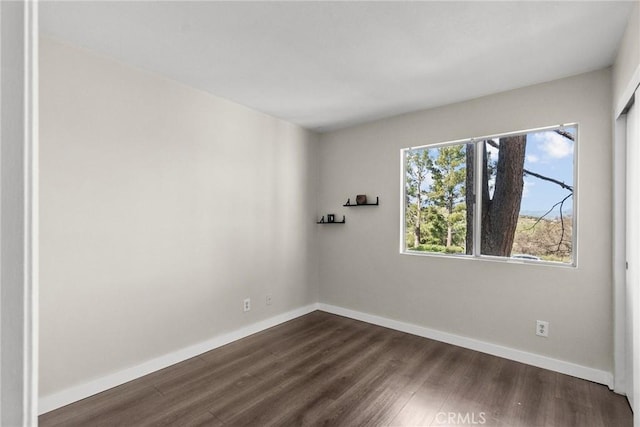 26762 Claudette St Unit 417, Canyon Country, CA 91351 - spare room featuring dark wood-style flooring and baseboards