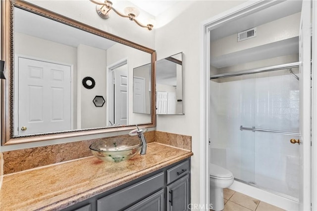 26762 Claudette St Unit 417, Canyon Country, CA 91351 - bathroom with vanity, a stall shower, tile patterned flooring, and toilet