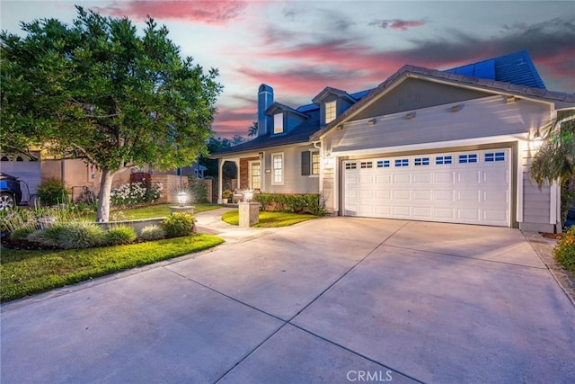 26941 Redwood Bluff Ln, Valencia, CA 91381 - view of front of home with driveway, an attached garage, and a chimney