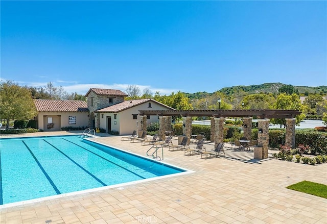 26941 Redwood Bluff Ln, Valencia, CA 91381 - community pool featuring a pergola, a patio area, and a mountain view