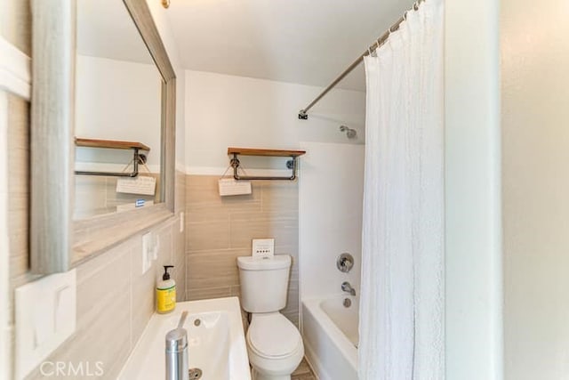 58725 Botkin Rd, Landers, CA 92285 - bathroom with toilet, tile walls, and shower / bath combo with shower curtain