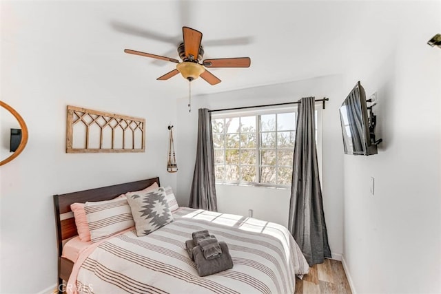 58725 Botkin Rd, Landers, CA 92285 - bedroom featuring baseboards, light wood finished floors, and a ceiling fan