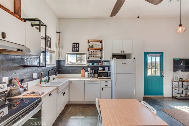 58725 Botkin Rd, Landers, CA 92285 - kitchen featuring stainless steel appliances, open shelves, concrete flooring, a sink, and backsplash