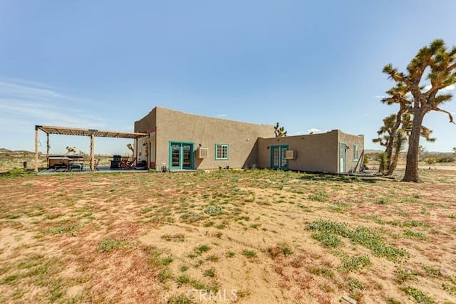 58725 Botkin Rd, Landers, CA 92285 - back of property featuring french doors, stucco siding, and a pergola