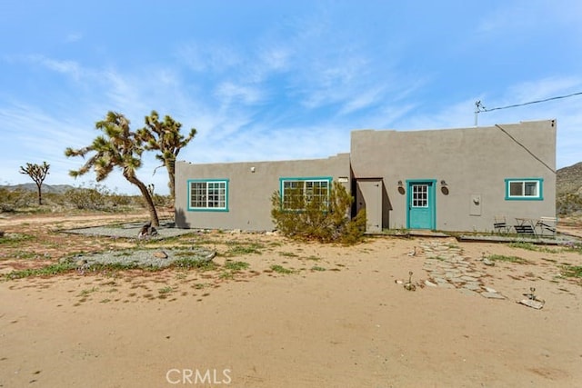 58725 Botkin Rd, Landers, CA 92285 - pueblo revival-style home featuring stucco siding