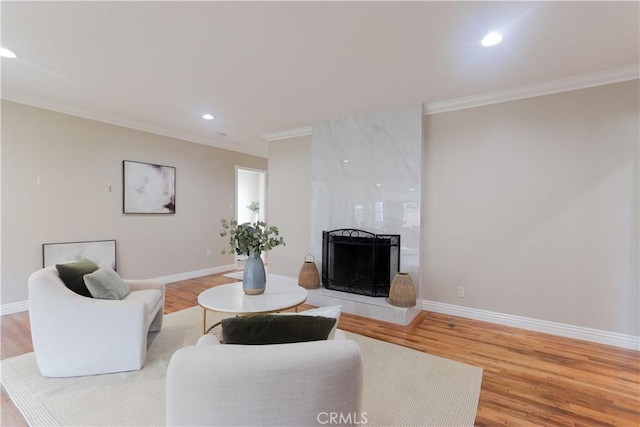 1023 W 186th St, Gardena, CA 90248 - living area with crown molding, light wood-style flooring, recessed lighting, a premium fireplace, and baseboards