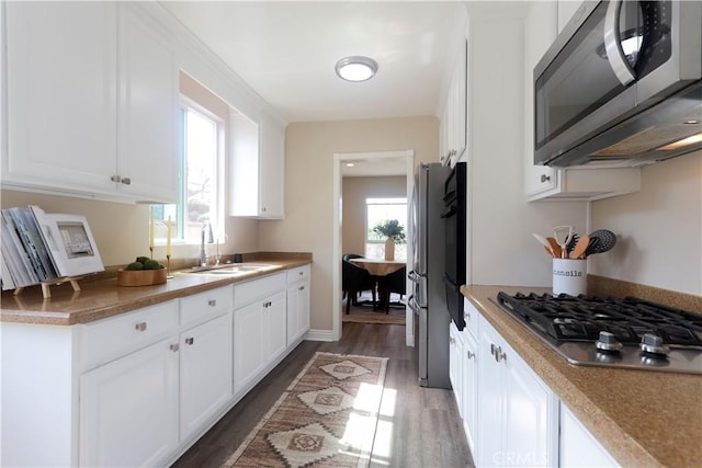 1023 W 186th St, Gardena, CA 90248 - kitchen with stainless steel appliances, a sink, light wood-style flooring, white cabinetry, and a warming drawer