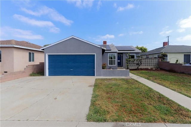 1023 W 186th St, Gardena, CA 90248 - ranch-style house with a garage, driveway, solar panels, and stucco siding