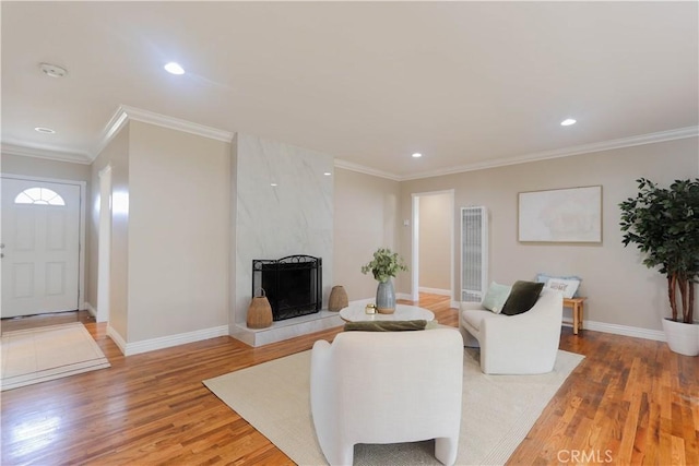 1023 W 186th St, Gardena, CA 90248 - living area with light wood-style flooring, a heating unit, recessed lighting, crown molding, and baseboards