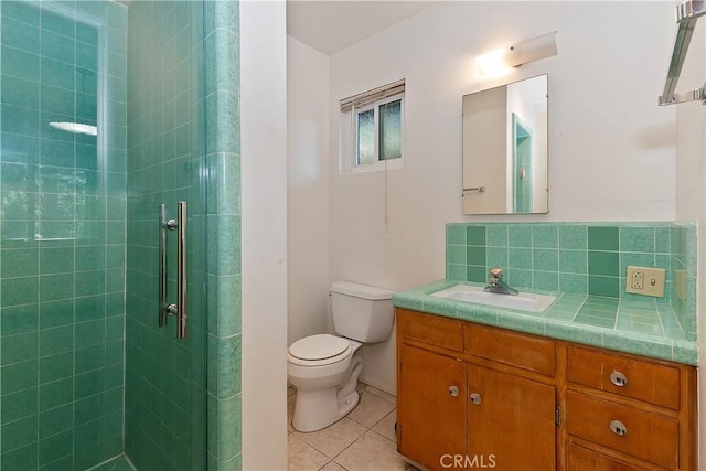 24141 Zell Ct, Crestline, CA 92325 - full bath with vanity, tile patterned floors, a shower stall, toilet, and backsplash