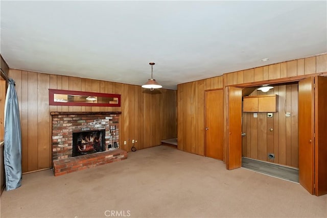 24141 Zell Ct, Crestline, CA 92325 - unfurnished living room featuring carpet, wood walls, and a fireplace