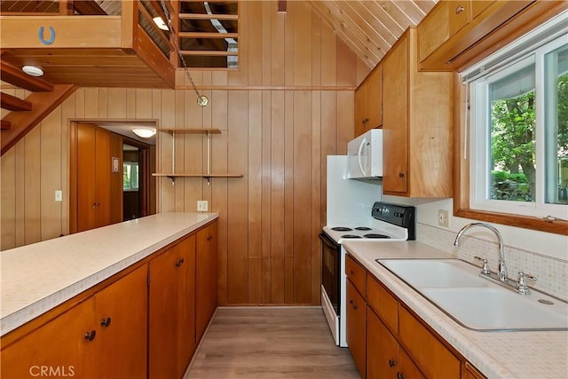 24141 Zell Ct, Crestline, CA 92325 - kitchen with electric range, white microwave, a sink, light countertops, and vaulted ceiling