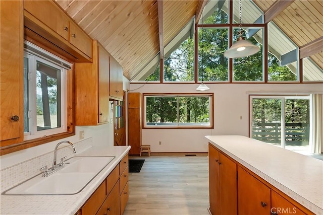 24141 Zell Ct, Crestline, CA 92325 - kitchen with a sink, light countertops, healthy amount of natural light, high vaulted ceiling, and wood ceiling