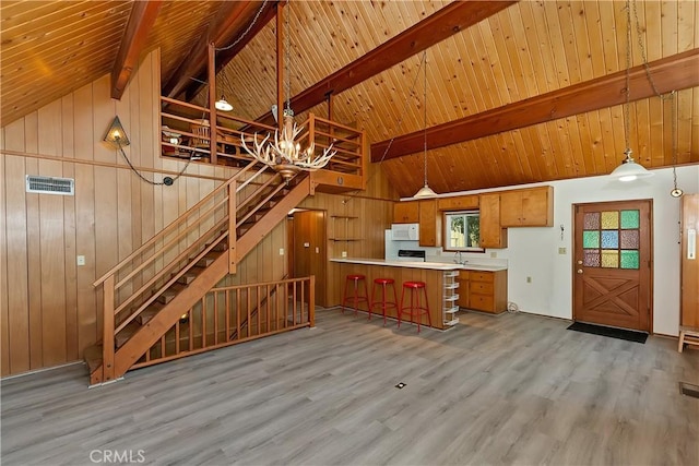 24141 Zell Ct, Crestline, CA 92325 - kitchen featuring white microwave, wood finished floors, wooden ceiling with exposed beams, high vaulted ceiling, and a chandelier