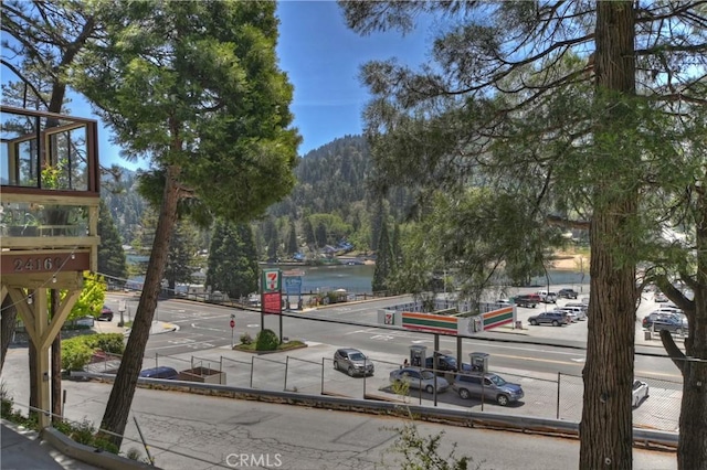 24141 Zell Ct, Crestline, CA 92325 - view of asphalt road with a water view, curbs, sidewalks, and traffic signs