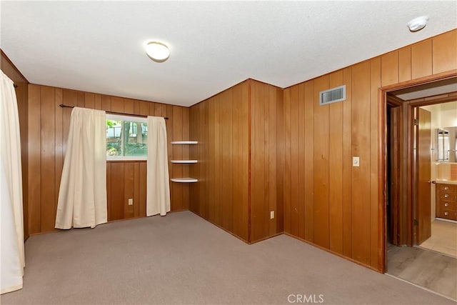 24141 Zell Ct, Crestline, CA 92325 - unfurnished room with wood walls, carpet flooring, and a smoke detector