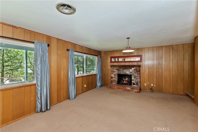 24141 Zell Ct, Crestline, CA 92325 - unfurnished living room featuring carpet flooring, a brick fireplace, and wooden walls