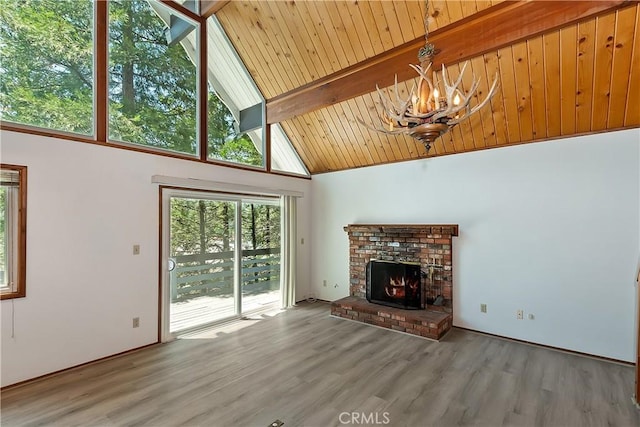 24141 Zell Ct, Crestline, CA 92325 - unfurnished living room with a chandelier, wood finished floors, beamed ceiling, high vaulted ceiling, and a brick fireplace