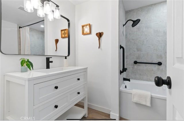 7686 Deer Trl, Yucca Valley, CA 92284 - full bath featuring vanity, shower / tub combo, baseboards, and wood finished floors