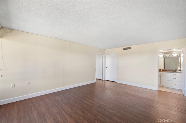 24055 Paseo Del Lago Unit 1206, Laguna Woods, CA 92637 - spare room with wood finished floors, a textured ceiling, baseboards, and bar